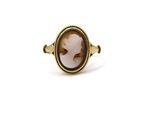 a close up of a gold ring with a stone in the center