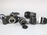 three cameras sitting next to each other on a table