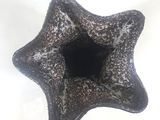 a black and white vase with a hole in it