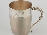a silver cup with a handle and a handle on it