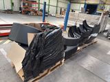 many pieces of furniture sitting on a pallet in a warehouse