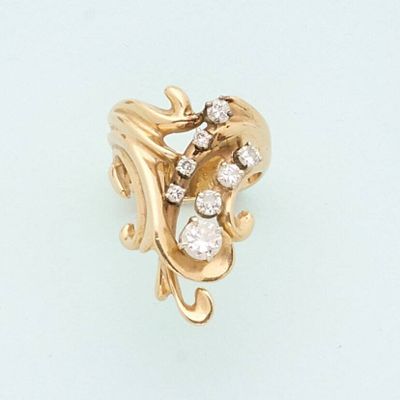an image of a gold and diamond ring on a white surface
