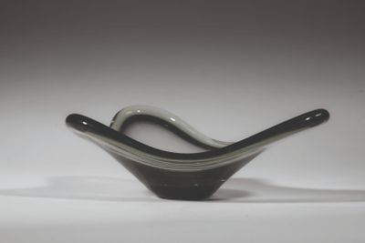 a black and white glass bowl sitting on a white surface