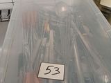 a plastic container filled with various tools on a kitchen counter