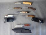 several different types of knives are laid out on a table