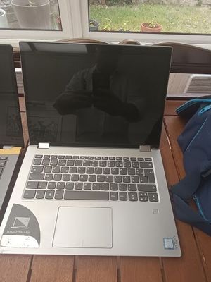 two laptops that are sitting on a wooden table