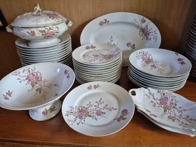 a lot of plates and bowls on the table