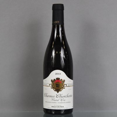 a bottle of wine sitting on top of a glass table