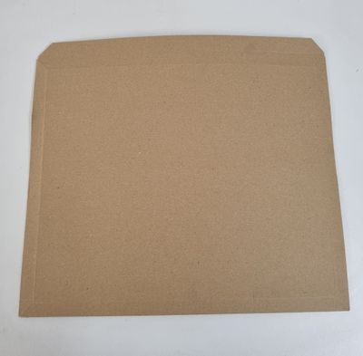 a piece of brown cardboard sitting on top of a white table