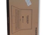 an open box with a laptop inside of it on a white surface