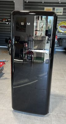 an image of a black refrigerator in a garage