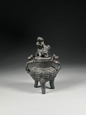 an old silverware with a bird on top of it
