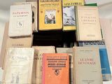 many books stacked on top of each other on a table