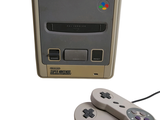 two game controllers sitting next to each other on a white surface