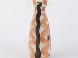 a small vase with a black and white design on it