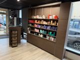 a photo of a hair salon with lots of products on the shelves
