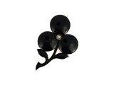 a picture of a black flower brooch with a diamond center