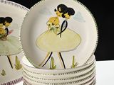 a stack of plates with a picture of a girl and a dog on them