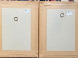 two framed paintings of a couple of rings hanging on a wall