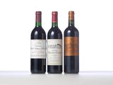 three bottles of wine are lined up on a table