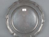 silver plate with scalloped edge on a gray background