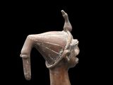 bronze statue of a woman with a bird on her head