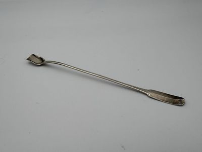 a close up of a spoon on a table with a white background