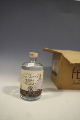 a bottle of alcohol sitting next to a box on a table