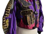 purple and black jacket on a mannequin stand with a white background