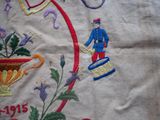 an embroidered picture of a man with a tennis racket and a vase