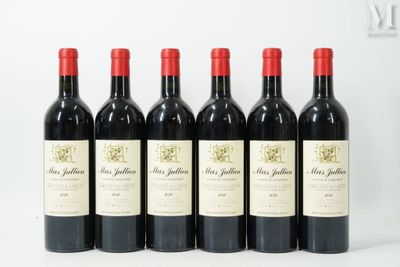 six bottles of red wine lined up in a row on a white surface