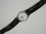 a close up of a wrist watch on a white surface