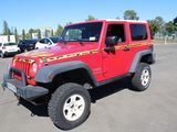 a picture of a red jeep parked in a parking lot