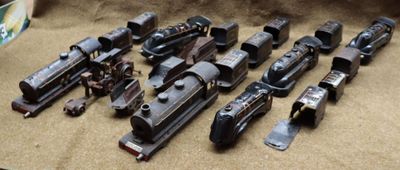 a lot of old toy trains sitting on a table