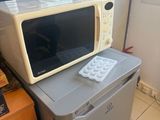 a microwave sitting on top of a refrigerator in a kitchen