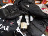 a bottle of wine and a pair of gloves on a table