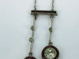 pair of diamond and garnett earrings on a silver chain