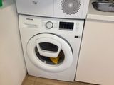 a washer and dryer in the corner of a kitchen