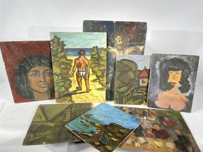 many paintings of people on display on a table