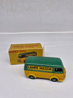 a toy bus that is sitting next to a box