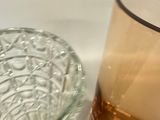 a glass bowl and a glass candle holder on a table