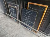 many menu boards on the counter of a restaurant