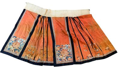 an orange and black skirt with a floral design on it