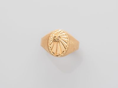 an image of a gold ring with a sun on it