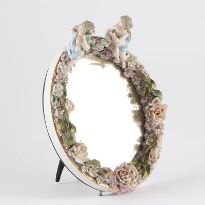 a mirror with a picture of two cherensils on it