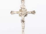 an antique silver crucif cross with a crown on it