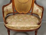 an image of a chair with a floral upholstered back and arms