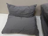 two pillows that are on the bed next to each other