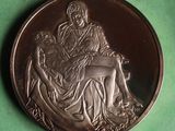 a silver coin with a picture of a woman and a dog on it