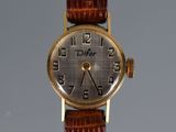 an image of a close up of a wrist watch on a table